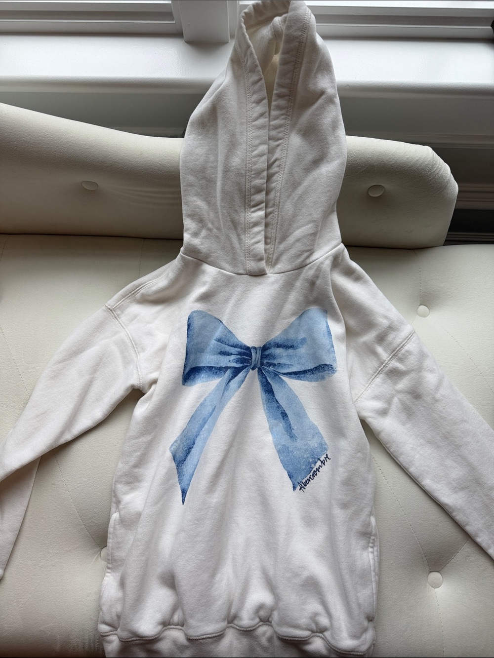 abercrombie kids Cream Hoodie with Blue Bow Graphic